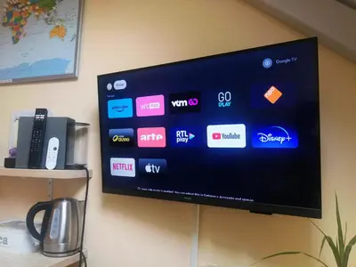 a flat screen tv hanging on a wall at B&B De Schorre in Boom