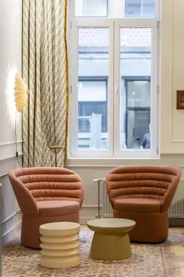 two chairs and a table in a room with a window at SHWAY - Le Lambermont in Antwerp