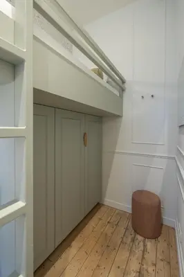a room with white cabinets and a wooden floor at SHWAY - Le Leopold in Antwerp