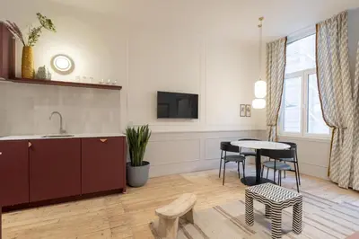 a kitchen and living room with a table and chairs at SHWAY - Le Leopold in Antwerp