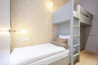 a small room with a bunk bed and a wall at SHWAY - Le Marnix in Antwerp