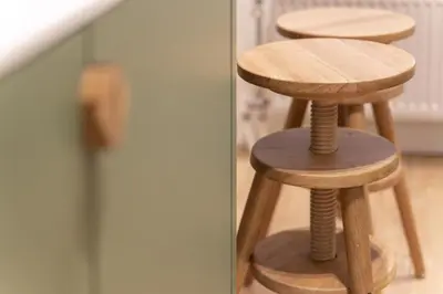 a couple of wooden stools sitting next to a door at SHWAY - Le Marnix in Antwerp