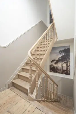 a staircase in a home with a painting on the wall at SHWAY - Le Marnix in Antwerp