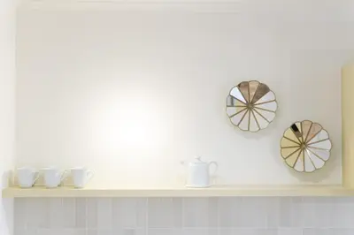 a shelf with bowls and plates on a wall at SHWAY Le Pierre in Antwerp