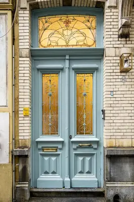 a blue door with two windows on a building at SHWAY Le Pierre in Antwerp