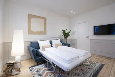 a living room with a couch and a tv at SHWAY Le Pierre in Antwerp
