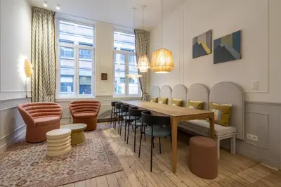 a dining room with a table and chairs at Maison Brederode Anvers in Antwerp