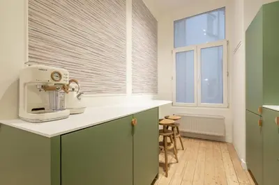 a kitchen with a mixer and a window at Maison Brederode Anvers in Antwerp