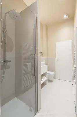 a bathroom with a glass shower and a toilet at Maison Brederode Anvers in Antwerp