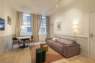 a living room with a couch and a table at Maison Brederode Anvers in Antwerp