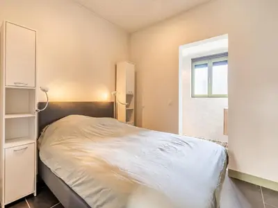 a bedroom with a bed and a window at Merksplas Villa with Terrace in Merksplas