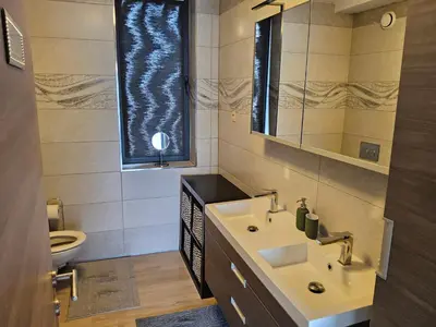 a bathroom with a sink and a mirror and a toilet at Chambre deluxe au 2ème étage, chambre double au 4ème étage NOT A HÔTEL in Brussels