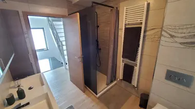 a bathroom with a walk in shower next to a door at Chambre deluxe au 2ème étage, chambre double au 4ème étage NOT A HÔTEL in Brussels