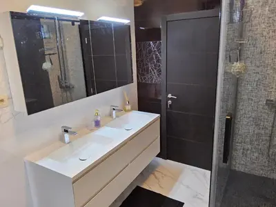 a bathroom with a white sink and a shower at Chambre deluxe au 2ème étage, chambre double au 4ème étage NOT A HÔTEL in Brussels