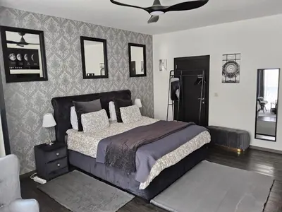 a bedroom with a bed and a black refrigerator at Chambre deluxe au 2ème étage, chambre double au 4ème étage NOT A HÔTEL in Brussels