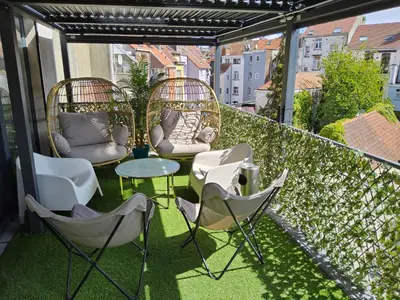 a patio with chairs and tables on a balcony at Chambre deluxe au 2ème étage, chambre double au 4ème étage NOT A HÔTEL in Brussels