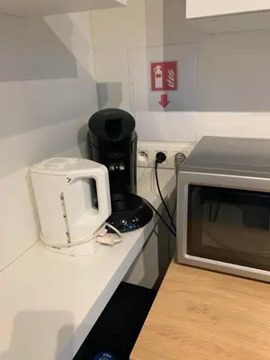 a microwave sitting on a counter next to a toaster at Prachtige gastsuite in Ranst 
