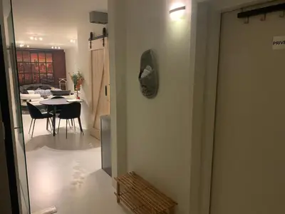 a room with a table and a dining room at Prachtige gastsuite in Ranst 