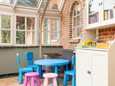 a kitchen with a blue table and chairs at Alverwege in Merksplas