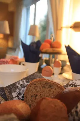 a table with bread and other foods on it at B&B Le 36 in Brussels