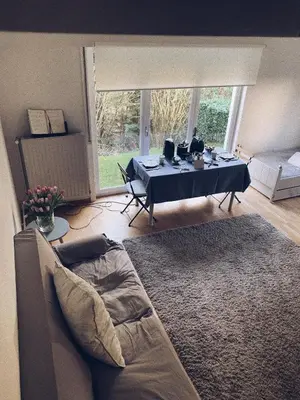 a living room with a table and a couch at B&B Le 36 in Brussels