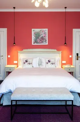 a bedroom with a white bed with red walls at The Old Beech in Antwerp