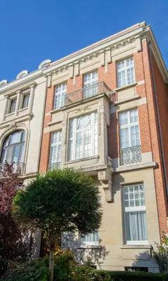 a large brick building with a clock on it at The Old Beech in Antwerp