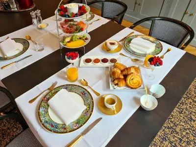 a table with plates of breakfast food on it at The Old Beech in Antwerp
