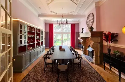 a dining room with a table and a fireplace at The Old Beech in Antwerp