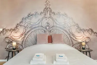 a bedroom with a white bed with two towels on it at TOP& ruim duplex woning in PATERSHOL,centrum Gent! in Ghent