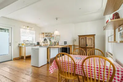 a kitchen and dining room with a table and chairs at TOP& ruim duplex woning in PATERSHOL,centrum Gent! in Ghent
