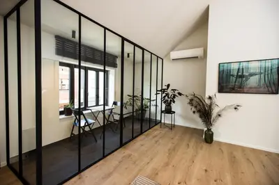 a room with glass walls and a table with a plant at The lodge Morris in Leuven