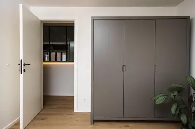 a room with white cabinets and a closet at The lodge Morris in Leuven