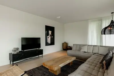 a living room with a couch and a coffee table at LXRYHOME Pendennis Castle in Brasschaat