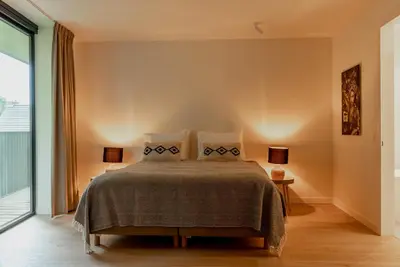 a bedroom with a bed with two pillows at LXRYHOME Pendennis Castle in Brasschaat