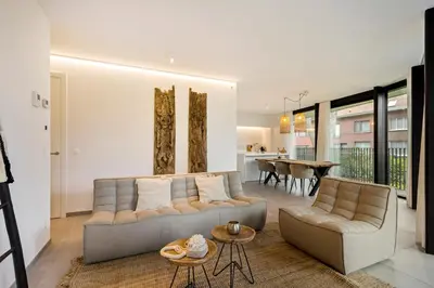 a living room with a couch and a table at LXRYHOME Pendennis Castle in Brasschaat