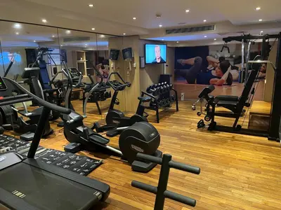 a gym with a lot of exercise equipment on the floor at Mercure Hotel Brussels Centre Midi in Brussels