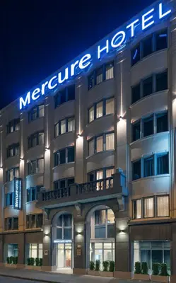 a large hotel building with a sign on it at Mercure Hotel Brussels Centre Midi in Brussels