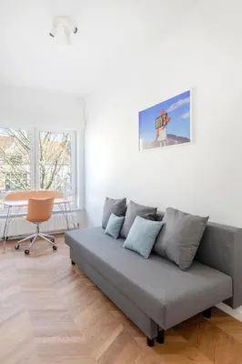 a living room with a couch and a desk at Molière Design Residence in Brussels