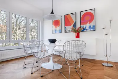 a dining room with a white table and chairs at Molière Design Residence in Brussels