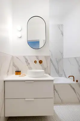 a white bathroom with a sink and a mirror at Molière Design Residence in Brussels