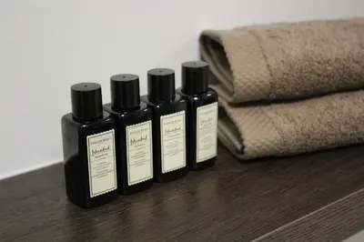 four bottles of essential oils sitting on a table at Maison Gand in Ghent