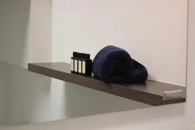 a shelf with a blue towel on a wall at Maison Gand in Ghent