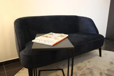 a black chair with a book on a table at Maison Gand in Ghent