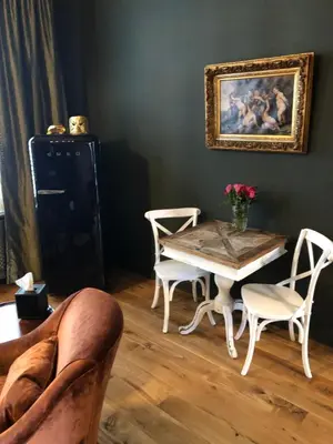 a living room with a table and chairs at Sint Andries Suites in Antwerp