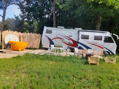 an rv with a painting on it parked next to a fence at Kromven On Wheels in Merksplas