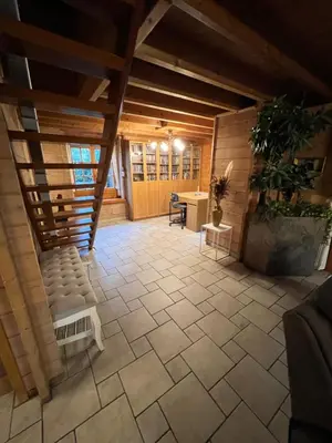 an attic room with a couch and a table at Panoramic Bungalow Sint Gillis-Waas in Sint-Gillis-Waas