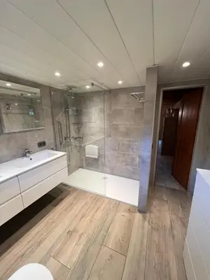 a bathroom with a tub and a sink and a shower at Panoramic Bungalow Sint Gillis-Waas in Sint-Gillis-Waas