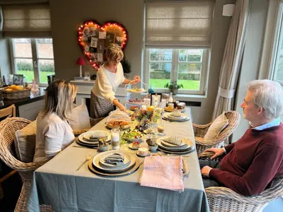 a group of people sitting around a table eating food at B&B 't klein GELUK in Ham