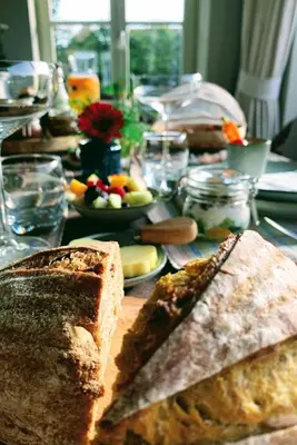 a table with bread and plates of food on it at B&B 't klein GELUK in Ham